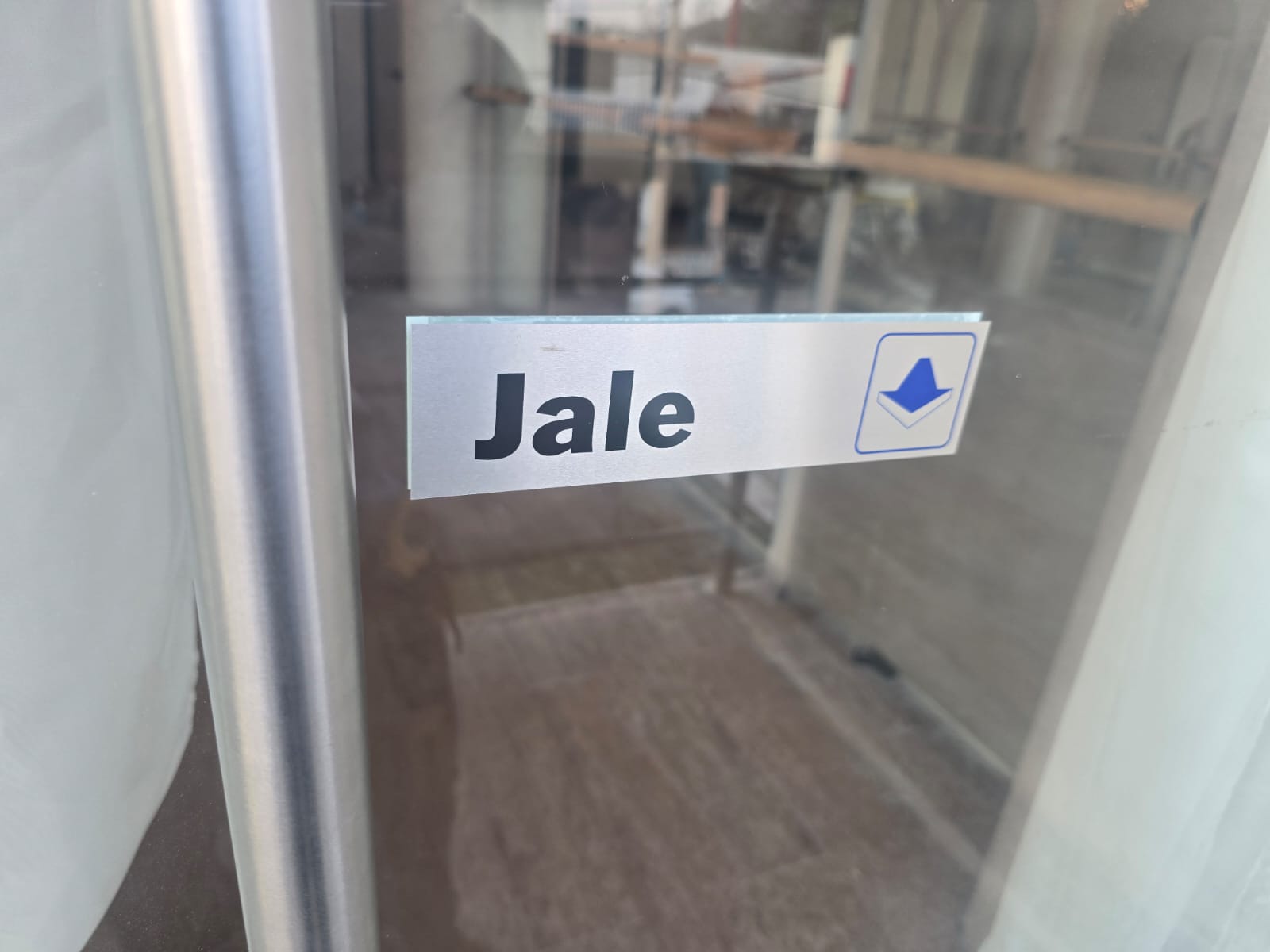 Señal de jale aplicada en puerta de vidrio